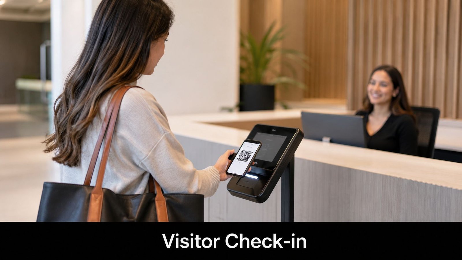 A woman checking in at an office reception by scanning a QR code on her smartphone screen.